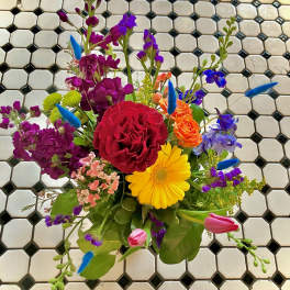 Mixed bouquet with red rose, yellow gerbera, and purple flowers