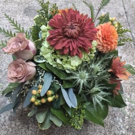 Bouquet of burgundy, peach, and blush flowers with greenery