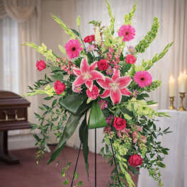 Tall standing floral spray with pink lilies, roses, and gerbera daisies