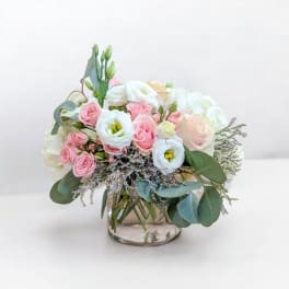 Pink and white bouquet in a clear glass vase