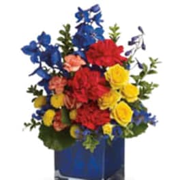 Bouquet of red, yellow, blue, and peach flowers in a blue vase
