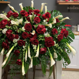Large arrangement of red roses and white calla lilies