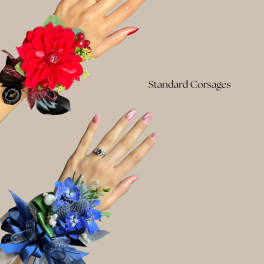 Two floral wrist corsages, one red and one blue, on hands