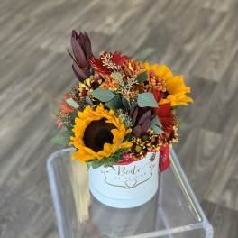 Sunflowers and mixed autumn flowers in a white hat box
