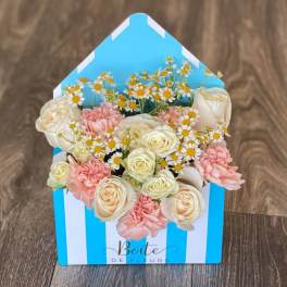 Box of cream roses, pink carnations, and small daisies