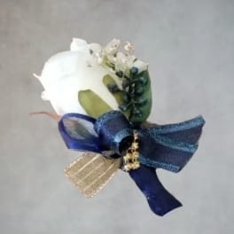 White rose boutonniere with blue ribbon and gold accent