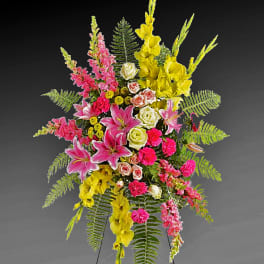 Tall standing floral spray with pink, yellow, and white blooms