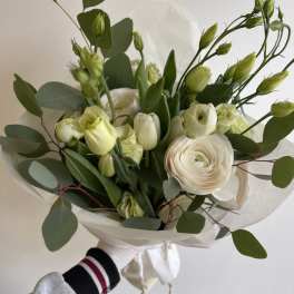 Hand-tied bouquet of white flowers with green buds and eucalyptus