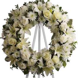White floral wreath on a standing easel