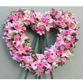 Heart-shaped pink floral wreath with ribbon tails