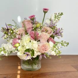 Pink and white floral arrangement in a clear glass vase