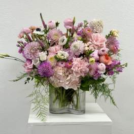 Pink and lavender mixed bouquet in a clear glass vase
