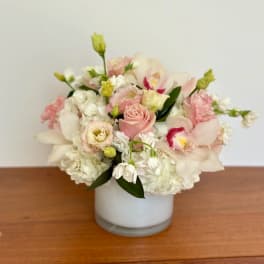Pink and white floral arrangement in a white vase