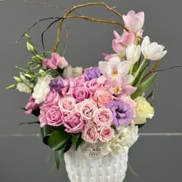 Pink and white floral arrangement in a white vase