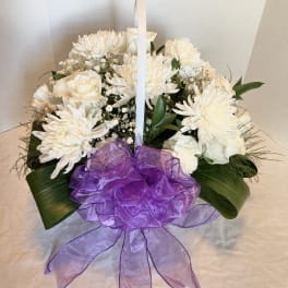 White floral basket arrangement with a purple ribbon bow