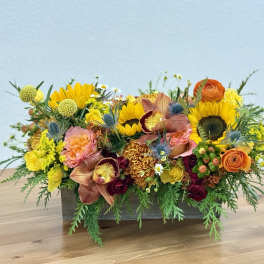 Mixed floral arrangement in a rectangular wooden container