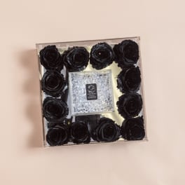 Square box of black roses with a clear jeweled center