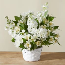 White flowers arranged in a white woven basket