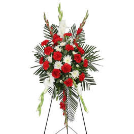 Standing funeral spray with red and white flowers on an easel