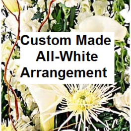 All-white floral arrangement with lilies, calla lilies, and spider mums