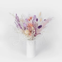 Pastel dried flower arrangement in a white vase