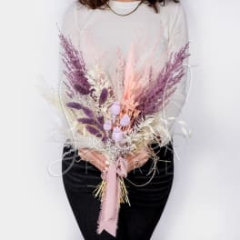 Bouquet of dried pink and purple grasses tied with a ribbon