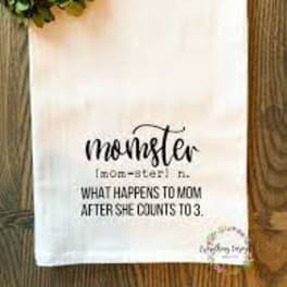 White towel with a floral wreath and "momster" text