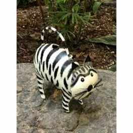 Black-and-white striped cat figurine on a stone surface