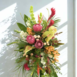Tall tropical standing arrangement with pink and orange flowers