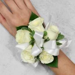 White rose wrist corsage with a satin ribbon