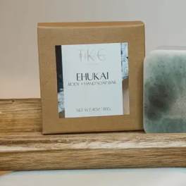 Boxed body and hand soap bar beside a green marbled soap bar