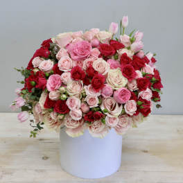 Large pink and red rose bouquet in a white box
