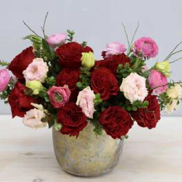 Red and pink rose bouquet in a gold vase