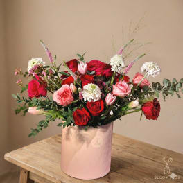 Pink and red rose bouquet in a blush cylindrical box