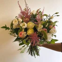 Handheld bouquet of white and pink flowers with tall pink accents