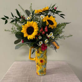 Sunflower bouquet in a decorative yellow vase