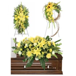 Yellow floral funeral arrangements displayed on and above a casket