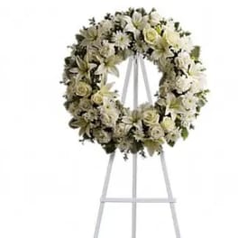 White floral wreath on a standing easel