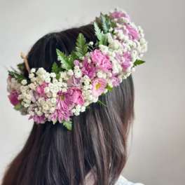 Pink and white flower crown worn on a person's head