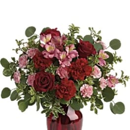 Red and pink bouquet in a red vase