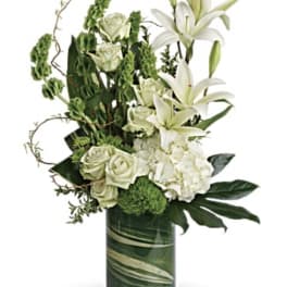 White lilies and roses arranged in a glass vase