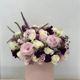 Pink and white floral arrangement in a blush cylindrical box