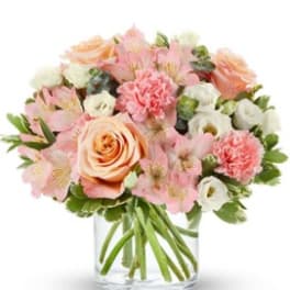Pink and peach bouquet in a clear glass vase