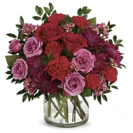 Bouquet of red and pink flowers in a clear glass vase