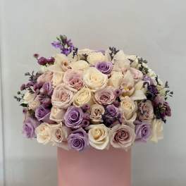 Pastel rose bouquet in a pink cylindrical box