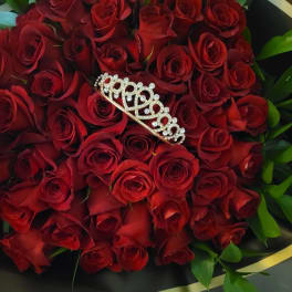 Bouquet of red roses with a jeweled tiara on top