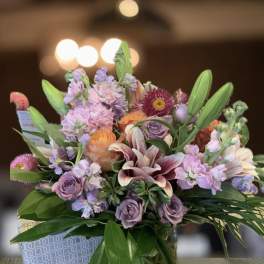 Mixed bouquet of pastel flowers in a glass vase