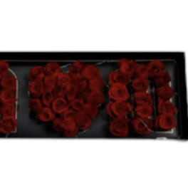 Red roses arranged to spell "MOM" in a black frame