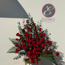 Large bouquet of red roses with eucalyptus and a red ribbon on a stand