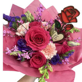 Bouquet of pink and purple flowers wrapped in pink paper